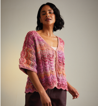 Load image into Gallery viewer, Woman wearing a pink and orange knitted cardigan against a neutral background